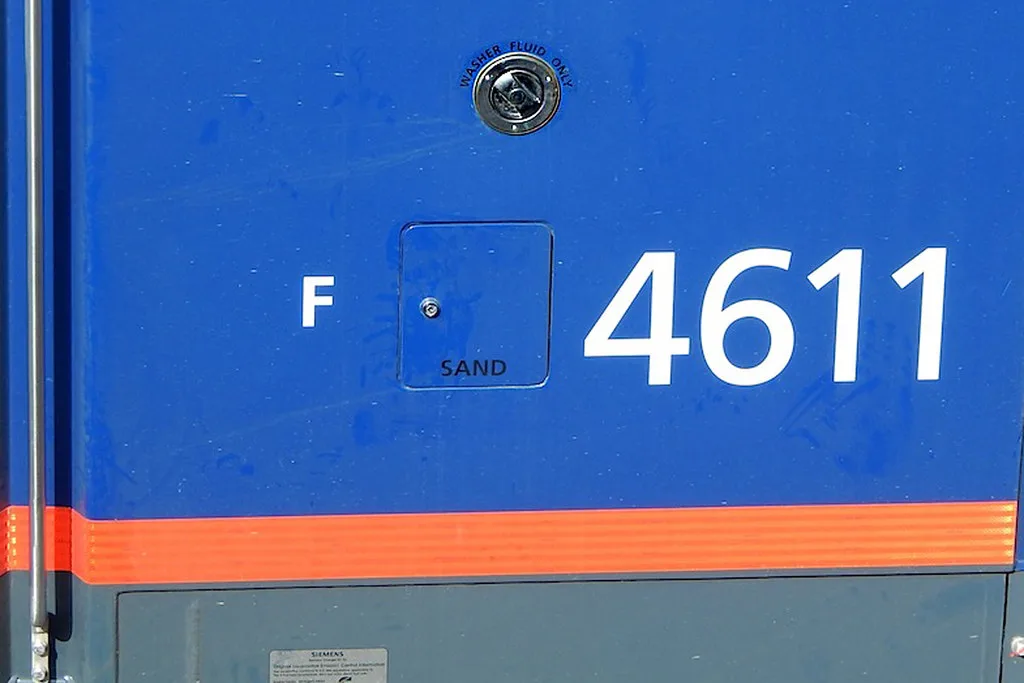 Close-up of washer fluid being poured into a car windshield reservoir on a cold day.