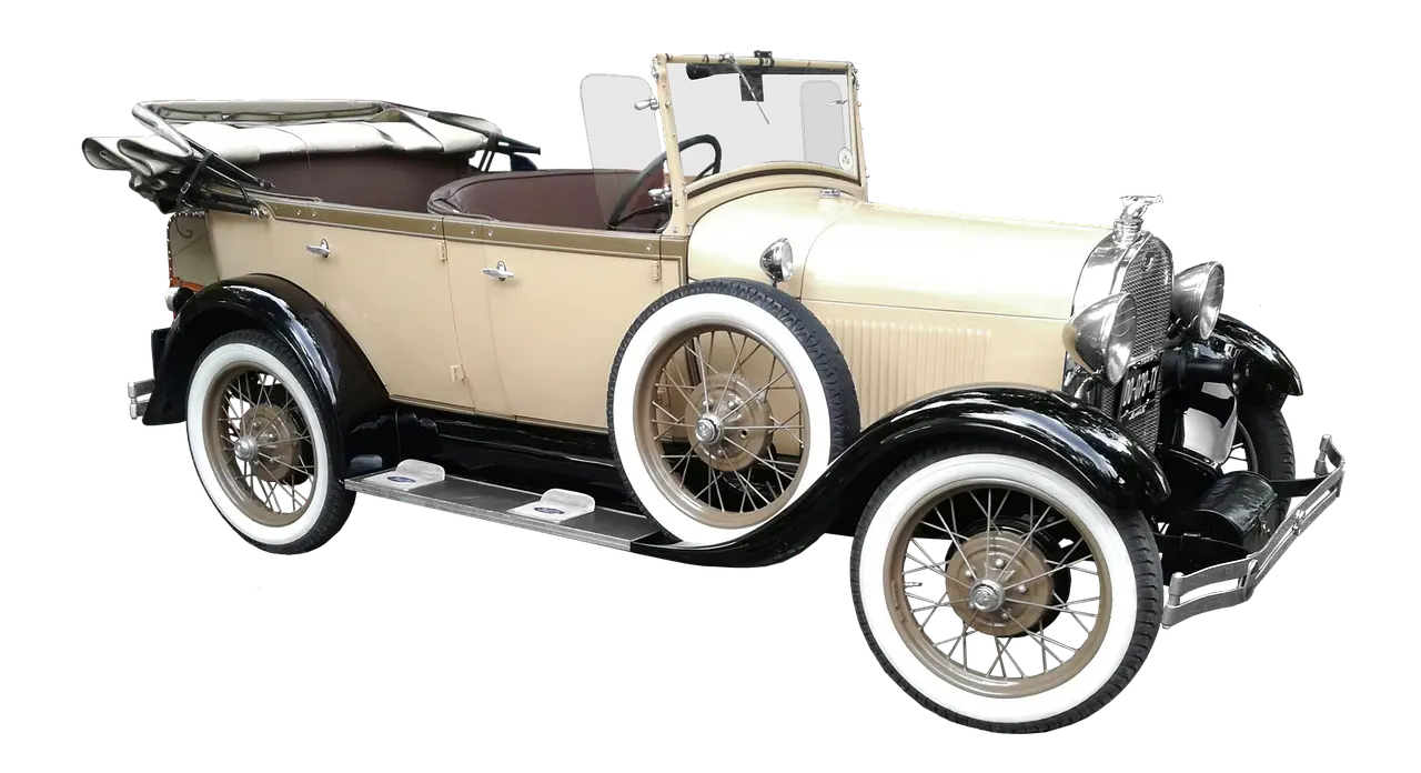 Classic coupe with polished wire wheels parked in natural light, showing period-correct stance and tire fitment.